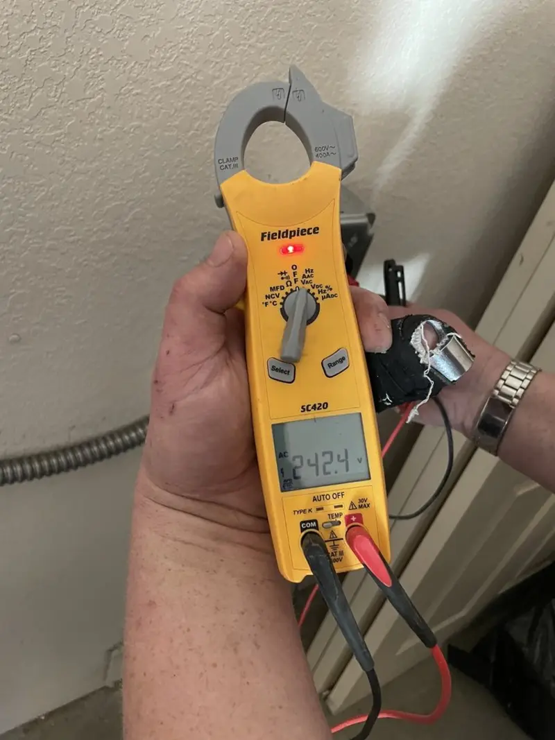 Voltage testing with clamp meter during Outlet Installation in Farmington